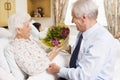 Senior Man Giving Flowers To His Wife In Hospital Royalty Free Stock Photo