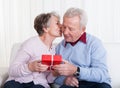 Senior Man Giving Gift To Senior Woman Royalty Free Stock Photo