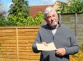 Senior man giving a plain brown envelope.