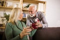 Senior man giving a present to his woman Royalty Free Stock Photo