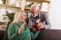 Man giving a present to his woman at home Royalty Free Stock Photo