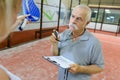 Senior man giving tennis lesson