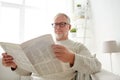 Senior man in glasses reading newspaper at home Royalty Free Stock Photo