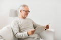 Senior man in glasses reading newspaper at home Royalty Free Stock Photo