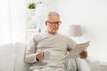 Senior man in glasses reading newspaper at home Royalty Free Stock Photo