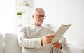 Senior man in glasses reading newspaper at home Royalty Free Stock Photo