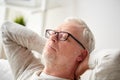 Senior man in glasses relaxing on sofa Royalty Free Stock Photo