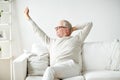 Senior man in glasses relaxing on sofa Royalty Free Stock Photo