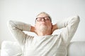 Senior man in glasses relaxing on sofa Royalty Free Stock Photo