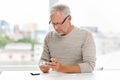 Senior man with glucometer checking blood sugar