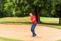 Senior man at golf having stroke in sand bunker Royalty Free Stock Photo