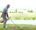 Senior, man or golfer playing golf for fitness, workout or exercise with a swing on a green course. Stroke, person Royalty Free Stock Photo