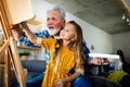 Senior man, grandfather and his grandchild drawing, painting together. Happy family time Royalty Free Stock Photo