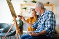 Senior man, grandfather and his grandchild drawing, painting together. Happy family time Royalty Free Stock Photo