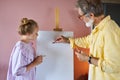 Senior man, grandfather and his granddaughter drawing, painting together Royalty Free Stock Photo