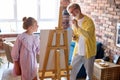 Senior man, grandfather and his granddaughter drawing, painting together Royalty Free Stock Photo