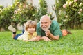 Senior man with grandson jogging in park. Cute child boy hugging his grandfather. Healthcare family lifestyle. Happy Royalty Free Stock Photo