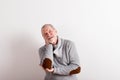 Senior man in gray woolen sweater, studio shot. Royalty Free Stock Photo