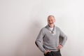 Senior man in gray woolen sweater, studio shot. Royalty Free Stock Photo