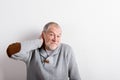 Senior man in gray woolen sweater, studio shot. Royalty Free Stock Photo