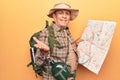 Senior man with grey hair wearing hiker backpack holding map celebrating achievement with happy smile and winner expression with Royalty Free Stock Photo