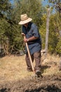 Senior man hand plowing in the field