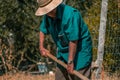 Senior man hand plowing in the field