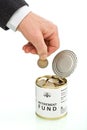 Senior man hand putting coin in retirement fund Royalty Free Stock Photo