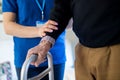 Close Up Of Senior Man With Hands On Walking Frame Being Helped By Care Worker Royalty Free Stock Photo