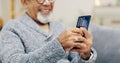 Senior man, happy and phone on sofa with texting, reading or typing for contact in home living room. Elderly person Royalty Free Stock Photo