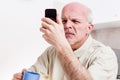 Senior man has problems with his vision Royalty Free Stock Photo