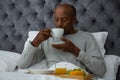 Senior man having breakfast on bed Royalty Free Stock Photo