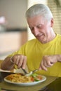 Senior man having breakfast Royalty Free Stock Photo