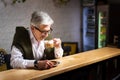 Senior man having a coffee in the bar Royalty Free Stock Photo