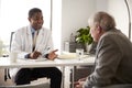 Senior Man Having Consultation With Male Doctor In Hospital Office Royalty Free Stock Photo