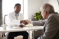 Senior Man Having Consultation With Male Doctor In Hospital Office Royalty Free Stock Photo