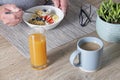 Close up of senior man having healthy muesli and yoghurt breakfast with orange juice Royalty Free Stock Photo