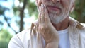 Senior man having problem with teeth, social program of dental prosthetics