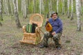 Senior man is having rest in birch forest