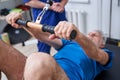 Senior man having trx lesson and working out with his coach in gym Royalty Free Stock Photo