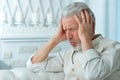 Senior man with headache holding hands on forehead Royalty Free Stock Photo