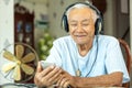 Senior man Headphones Listening Music at home Royalty Free Stock Photo