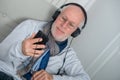 Senior man in headphones listening to music at home Royalty Free Stock Photo