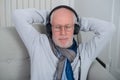 Senior man in headphones listening to music at home Royalty Free Stock Photo