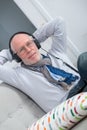 Senior man in headphones listening to music at home Royalty Free Stock Photo