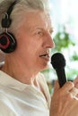 Senior man in headphones singing Royalty Free Stock Photo