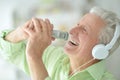 Senior man in headphones singing Royalty Free Stock Photo