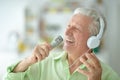 Senior man in headphones singing Royalty Free Stock Photo