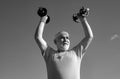 Senior man in health club. Old mature man exercising with dumbbell. Portrait of senior man holding dumbbell. Senior male Royalty Free Stock Photo