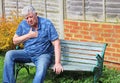 Senior man heart attack, difficulty breathing. Royalty Free Stock Photo